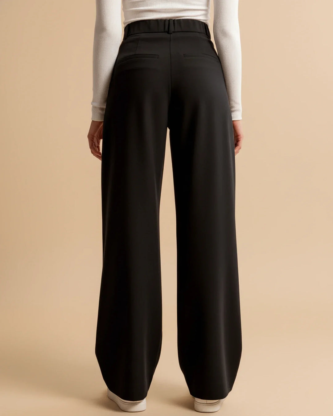 Women's pleated trousers in beige showing versatile styling for work or weekend