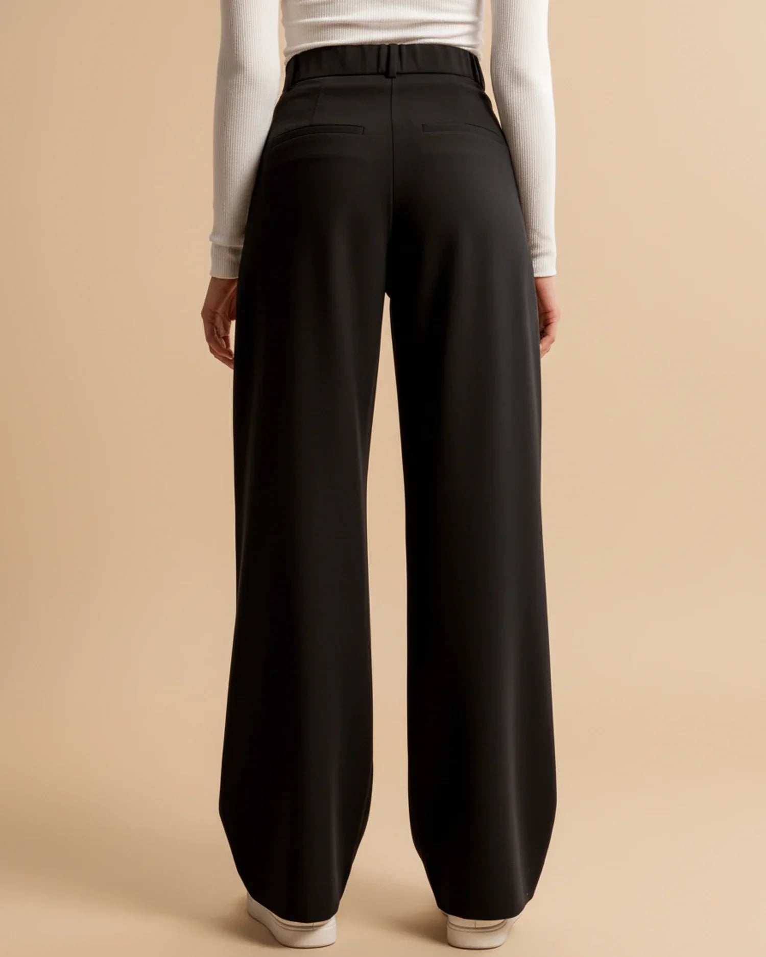 Women's pleated trousers in beige showing versatile styling for work or weekend