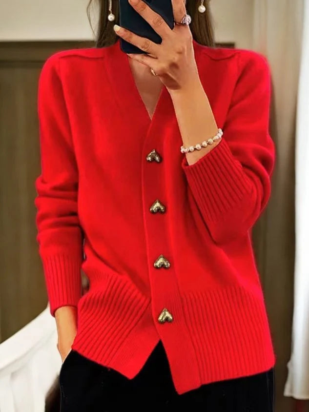 Women's knit cardigan with V-neck and button-down front layered over casual separates