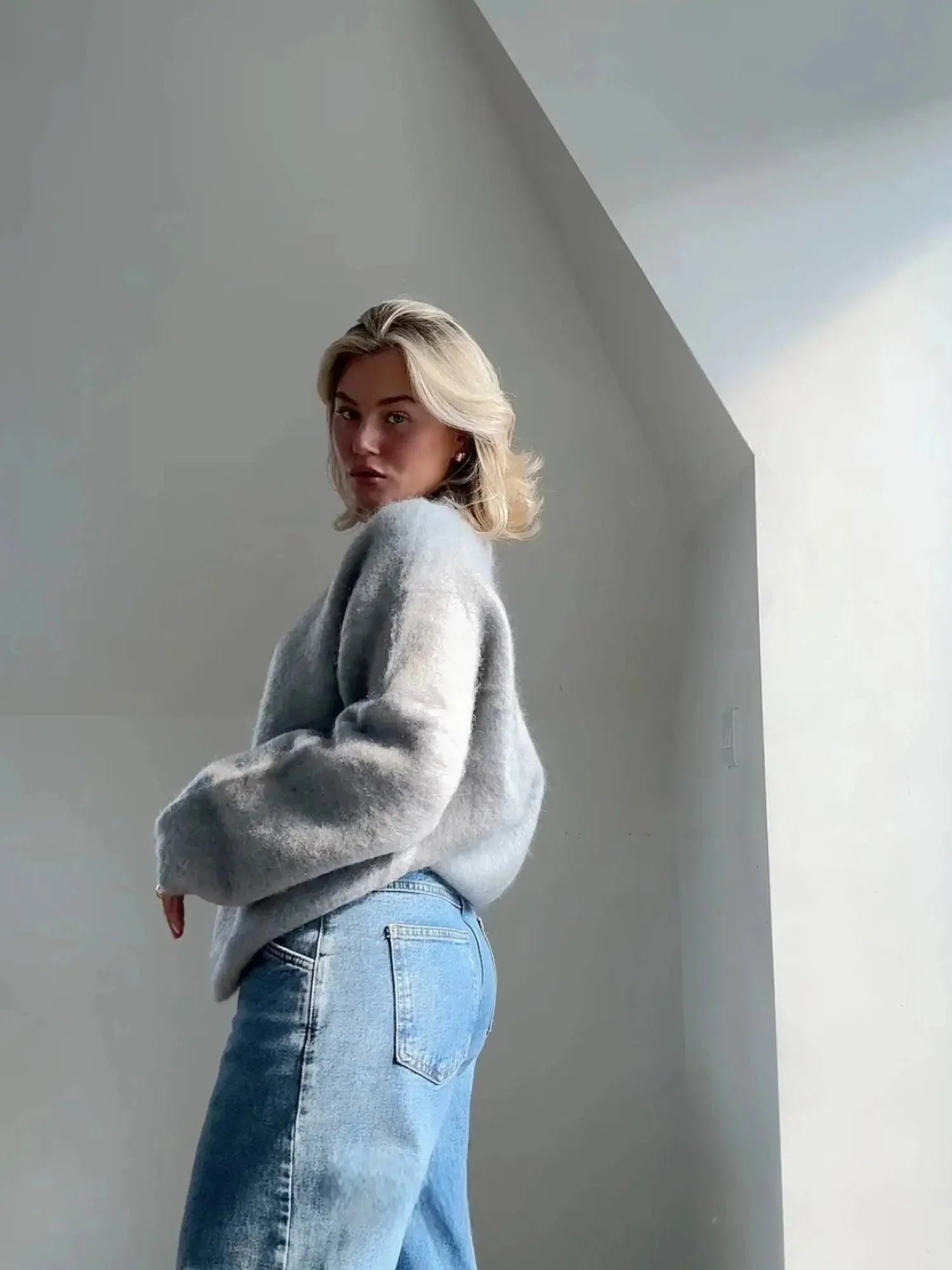 Close-up view of oversized crew neck jumper showing fluffy knit texture and ribbed neckline