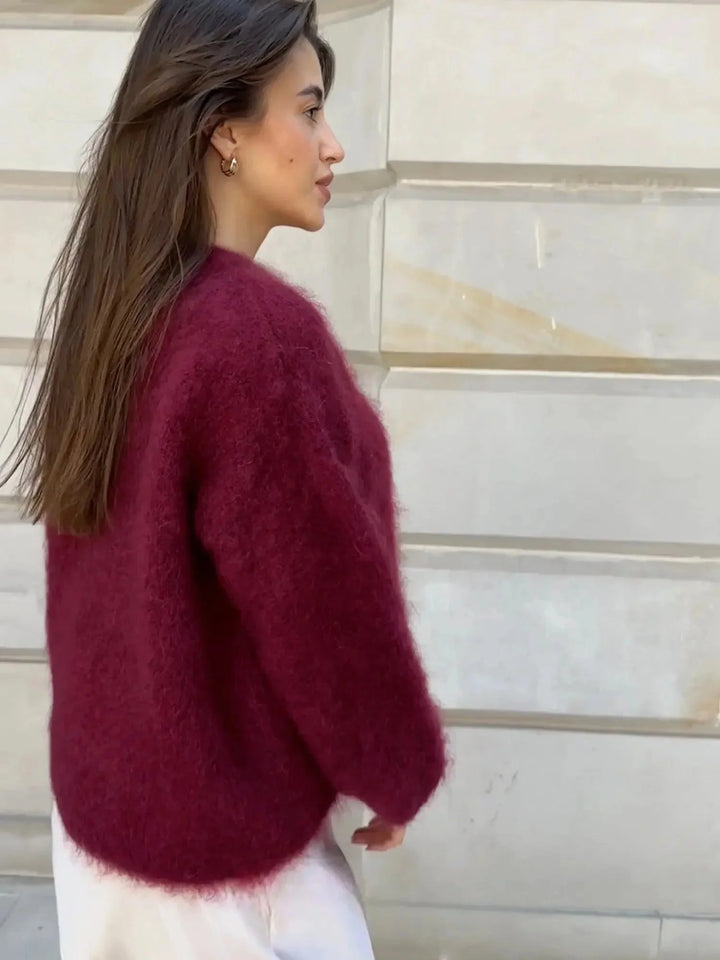 Woman styling oversized crew neck jumper with denim jeans for casual autumn outfit