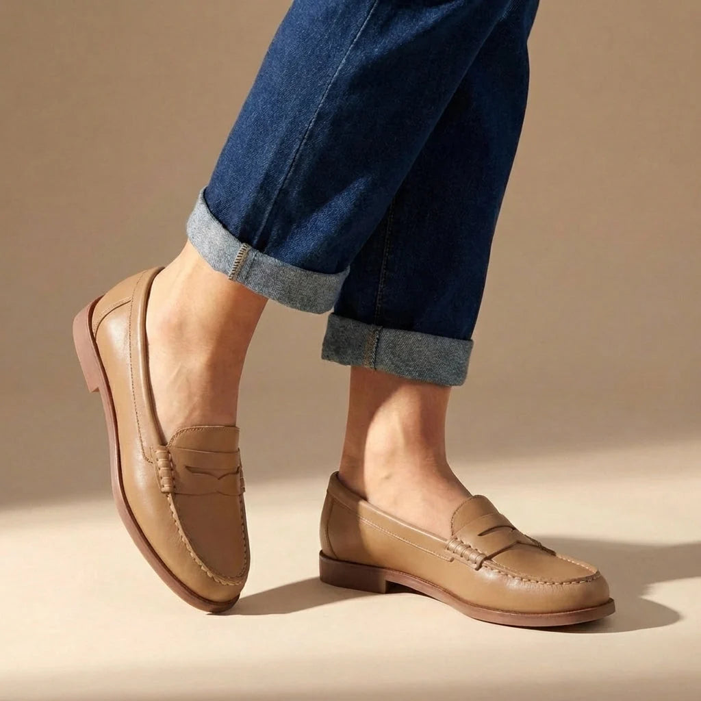 Side view of women's penny loafers with low block heel and hand-stitched moccasin detailing