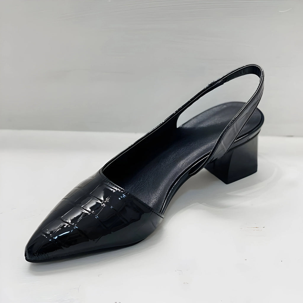 Women's pointed flats with slingback design styled with black trousers and chain anklet