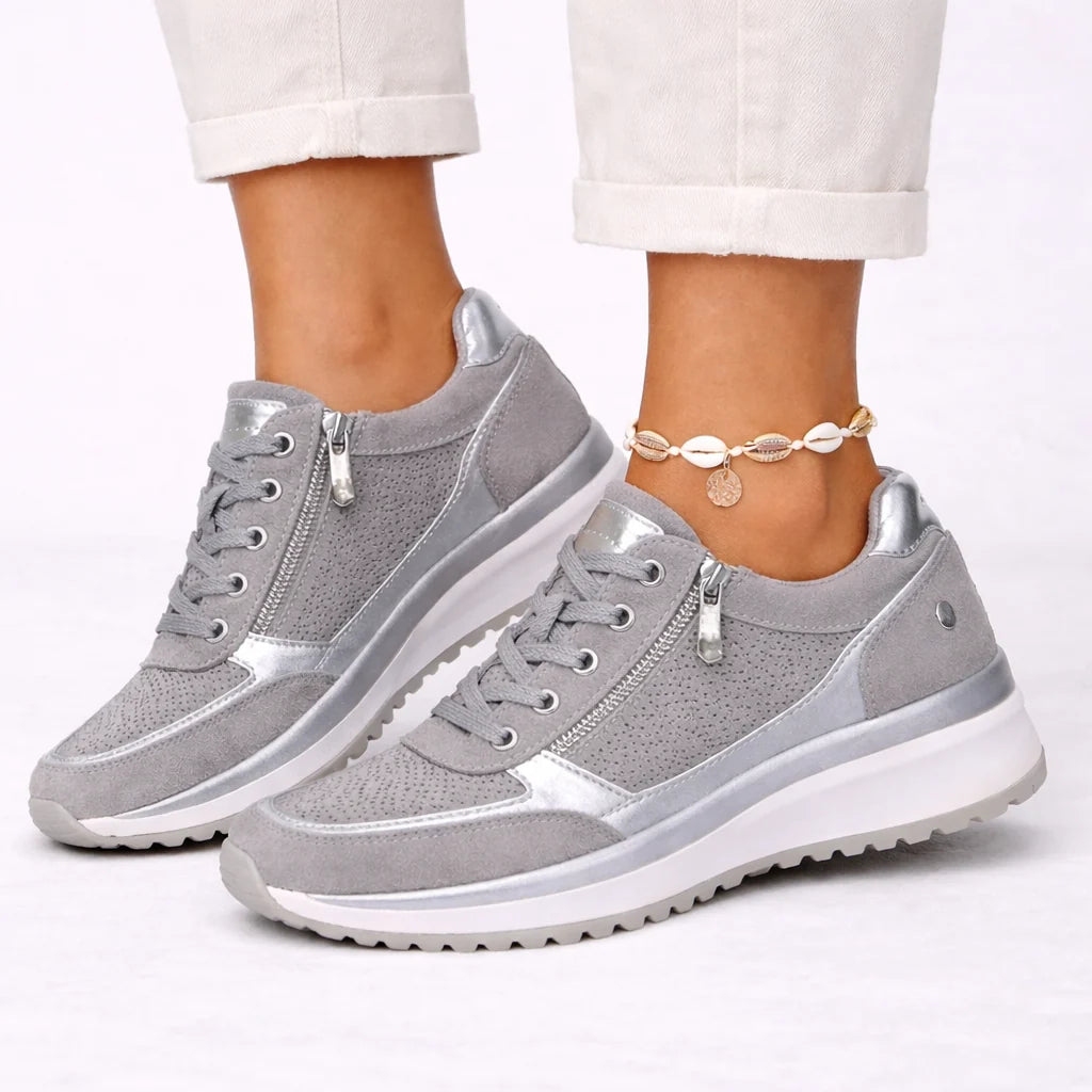 Women's trainers with side zip closure and lace-up front, featuring perforated panels and metallic heel detail in grey