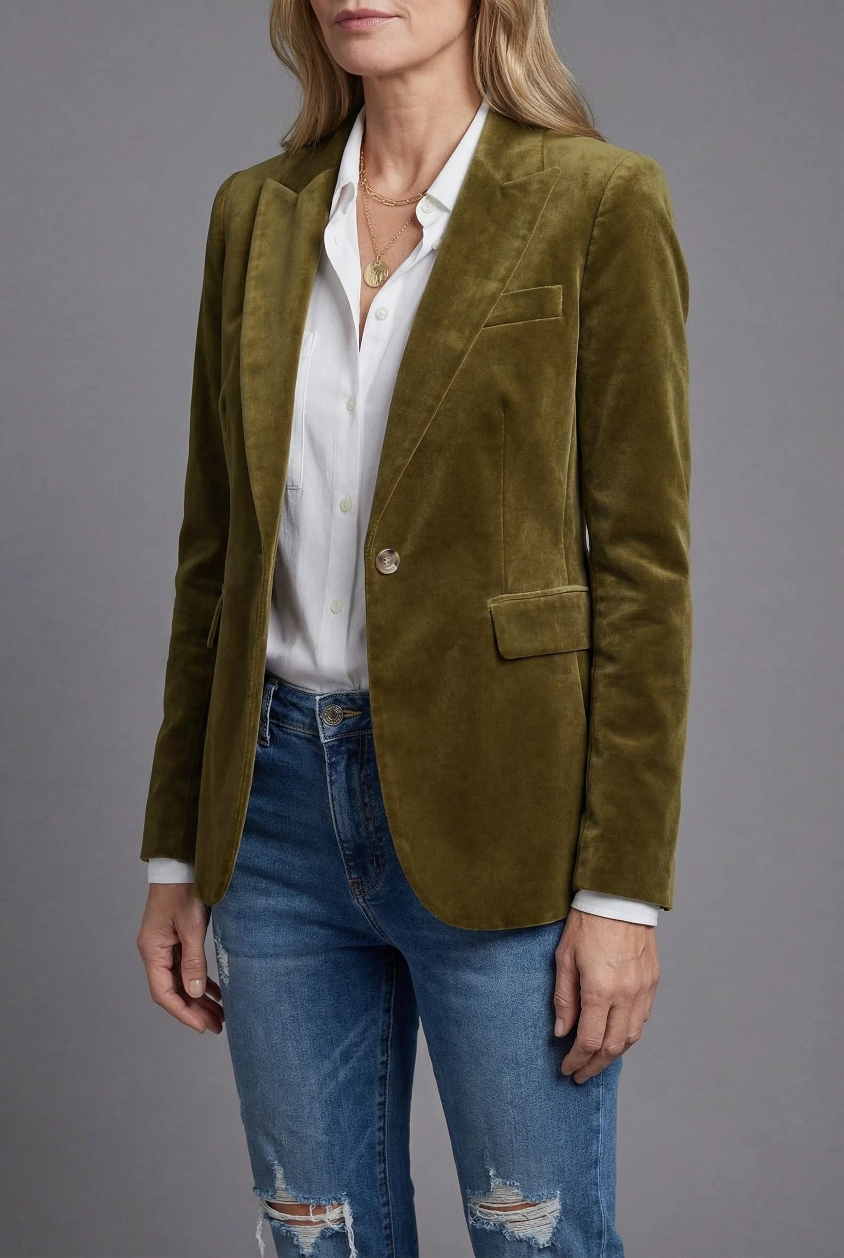 Close-up of velvet tailored blazer showing plush fabric texture and structured shoulders with notched lapel detail