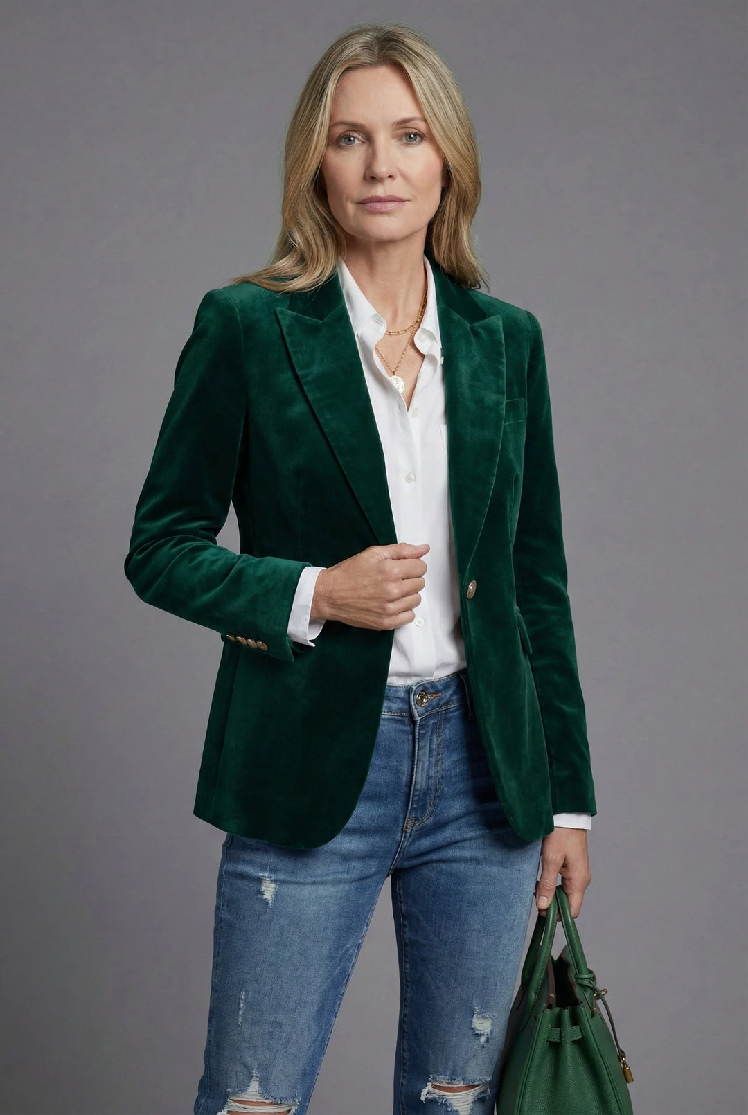 Detail of velvet blazer single-button closure and smooth fabric finish with structured tailoring