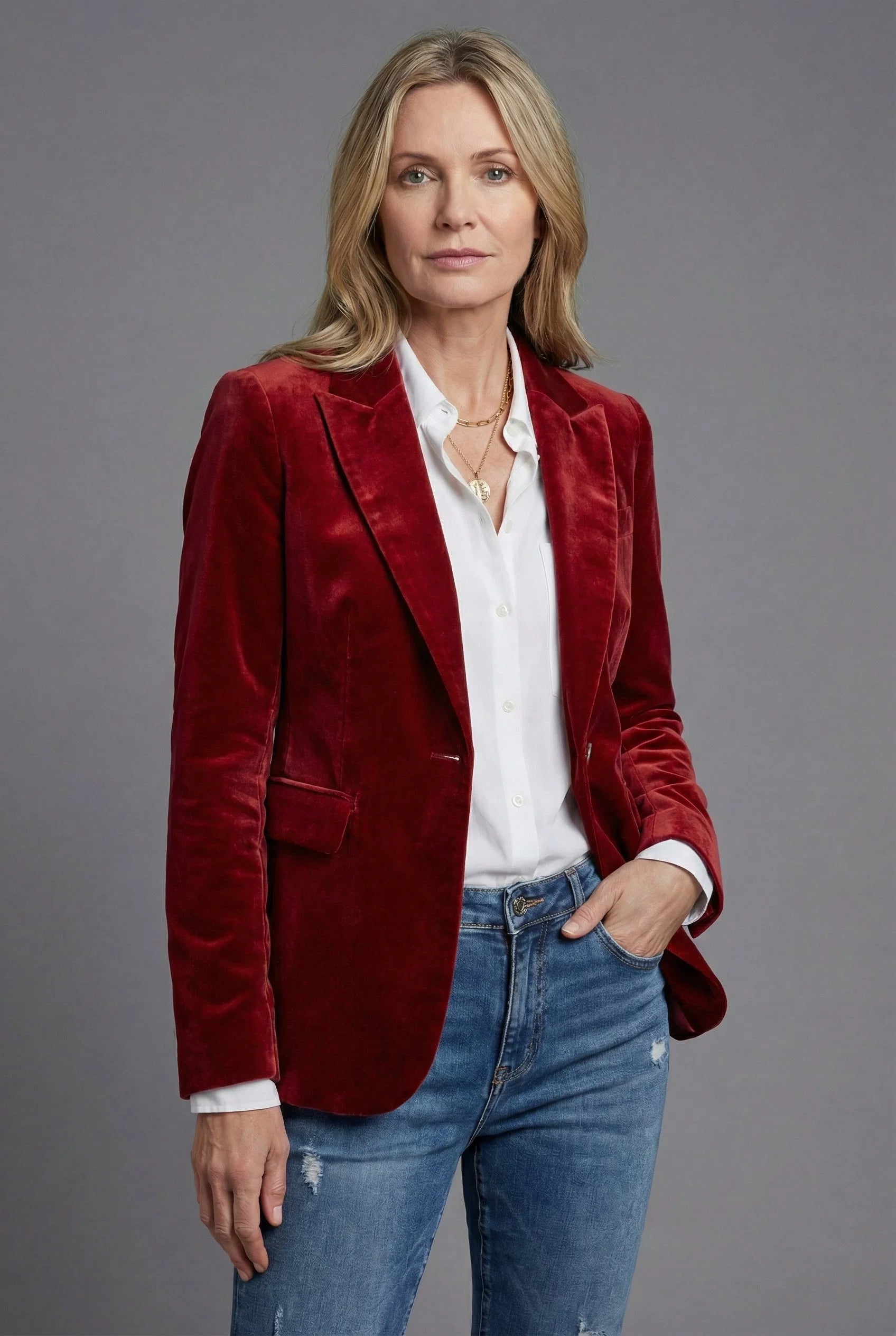 Women's velvet blazer worn open over white shirt showcasing notched lapels and tailored cut