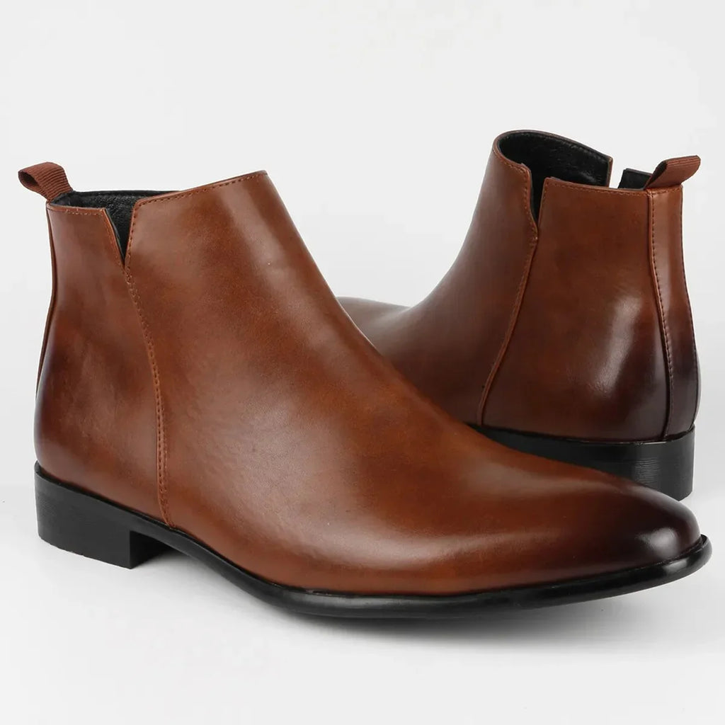 Detailed view of men's Chelsea boots showing low block heel and structured sole