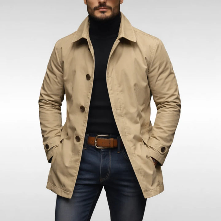 Detail of quilted lining and button closure on men's trench coat