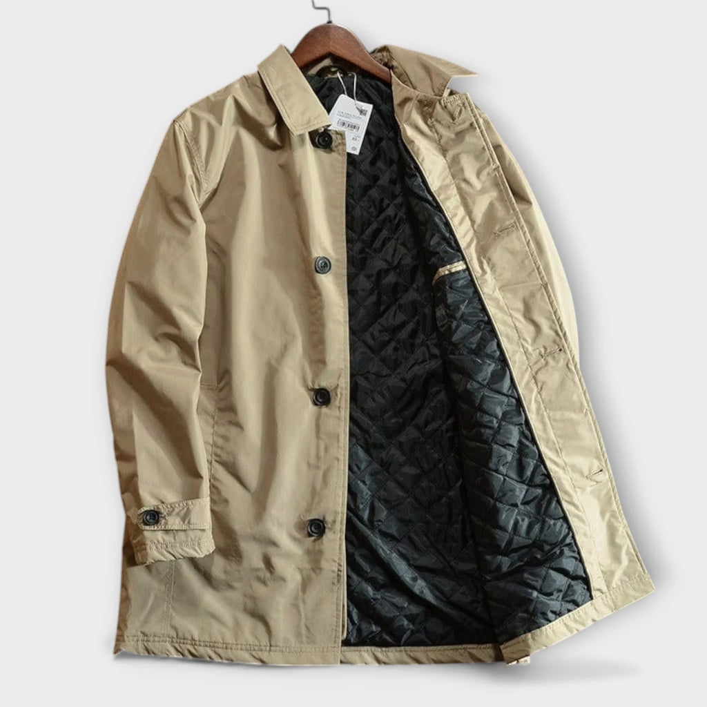 Back view of men's tailored trench coat showing structured shoulders and length