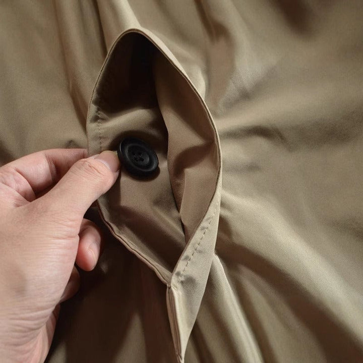 Men's insulated trench coat showing notched collar and button-front design