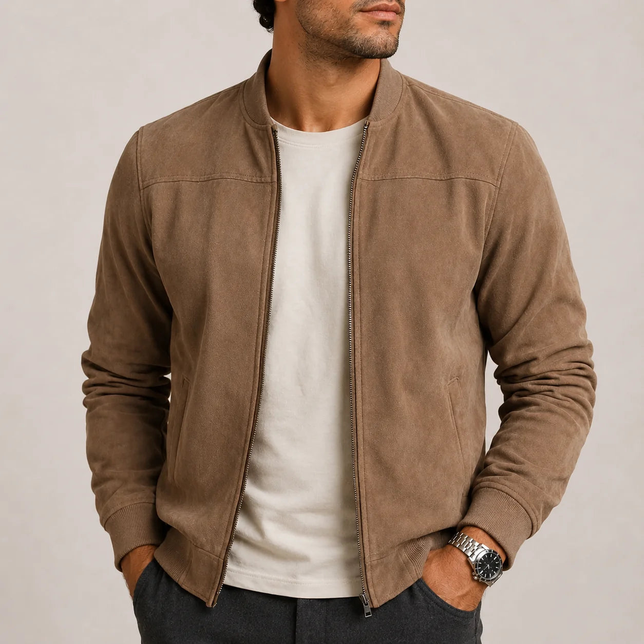 Men's suede bomber jacket in taupe with ribbed collar and full zip closure worn over white tee