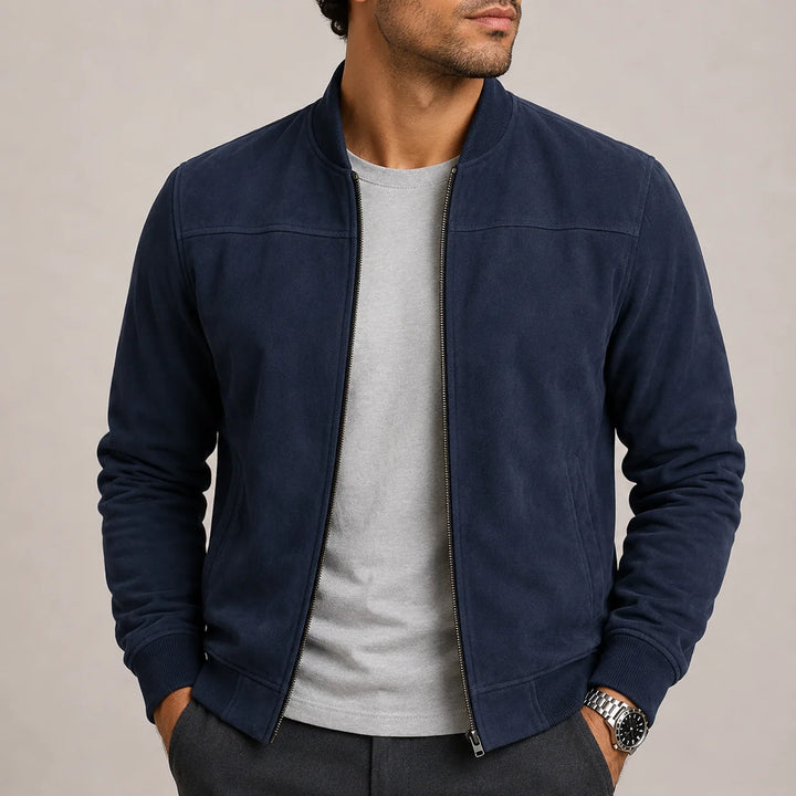 Men's suede bomber jacket styled with dark trousers showing versatile casual outerwear look