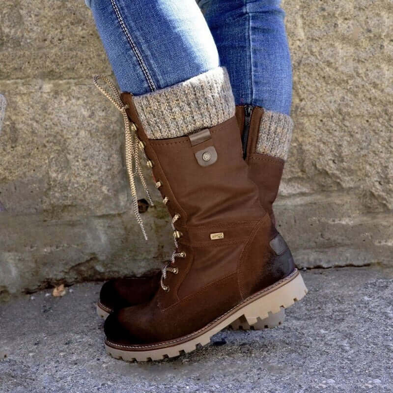 Men's lace-up winter boots with side zip and chunky sole worn with turned-up jeans