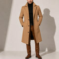 Men's long overcoat in camel with tailored fit and single-breasted button closure, worn over black turtleneck and brown trousers