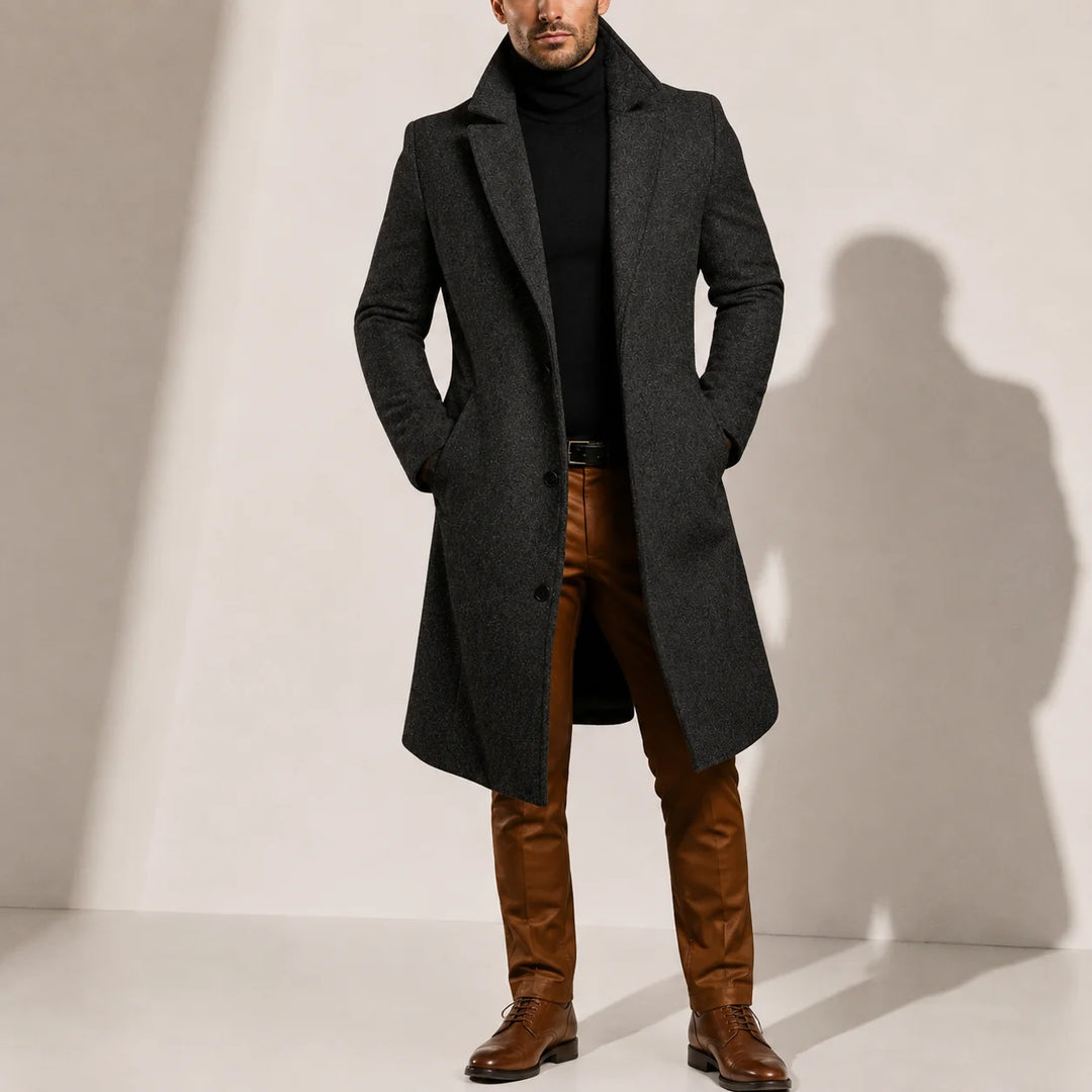 Side view of men's long overcoat displaying tailored silhouette and side pocket placement