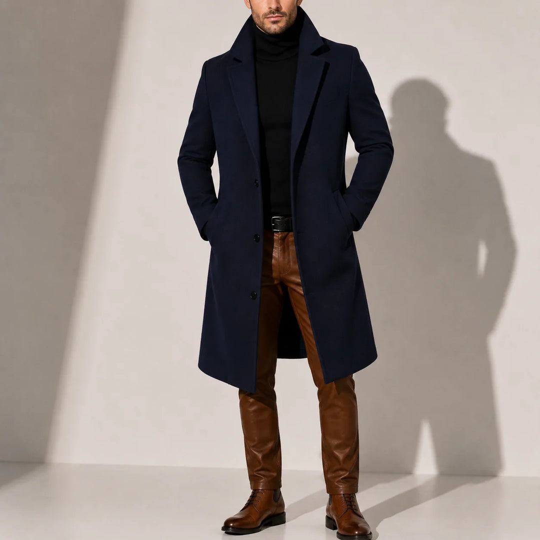 Rear view of men's long overcoat showing knee-length cut and refined drape
