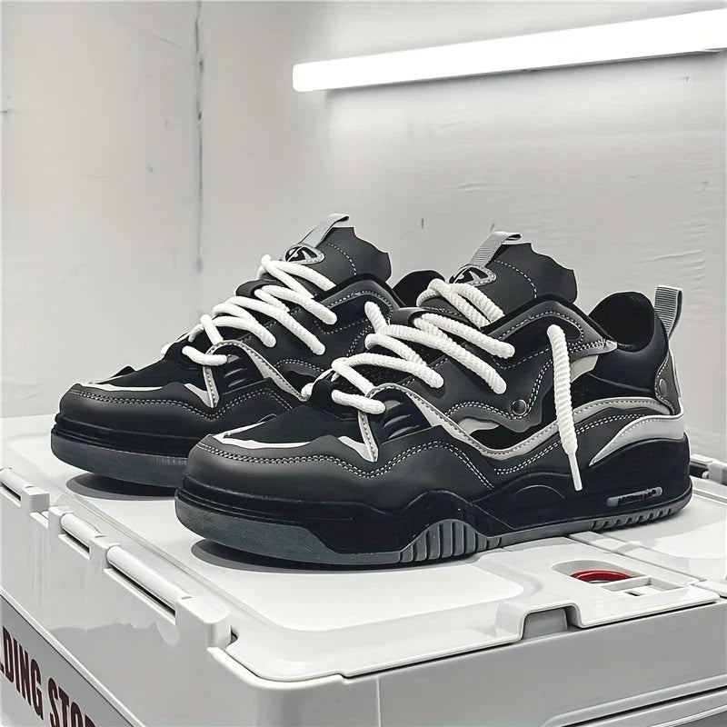 Men's chunky trainers in black with layered overlays and white laces on display shelf