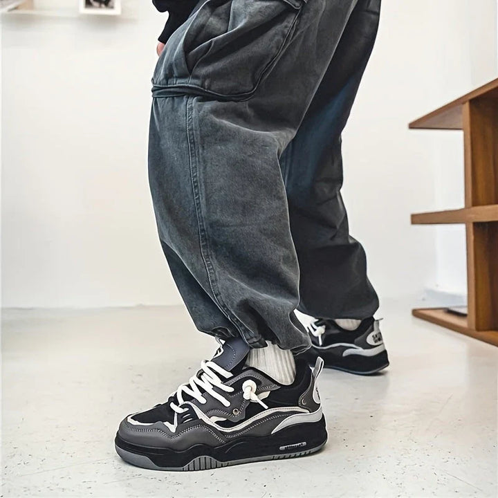 Men's chunky trainers in black with structured upper and sporty silhouette from angle