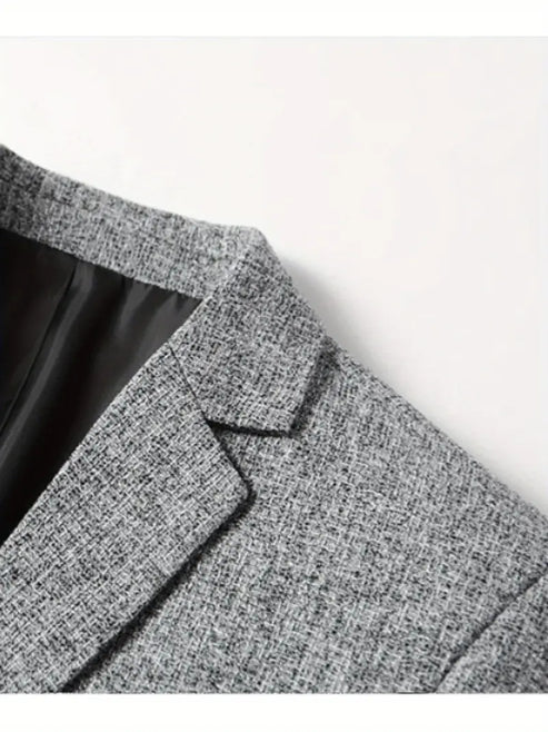 Close-up view of men's grey blazer showing notched lapels and structured shoulders