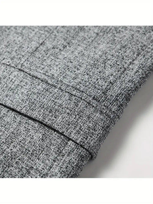 Side profile of men's tailored blazer displaying slim silhouette and functional pockets