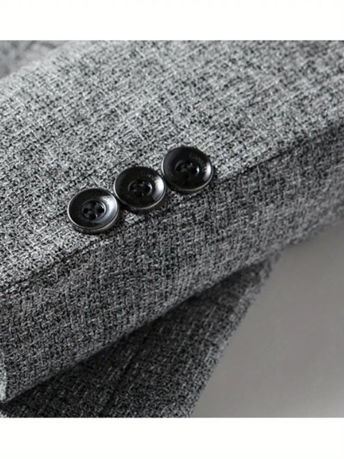 Men's grey blazer paired with black trousers for smart casual office look