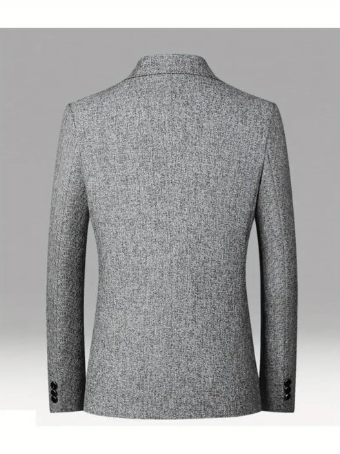 Detail shot of men's blazer two-button closure and woven fabric texture