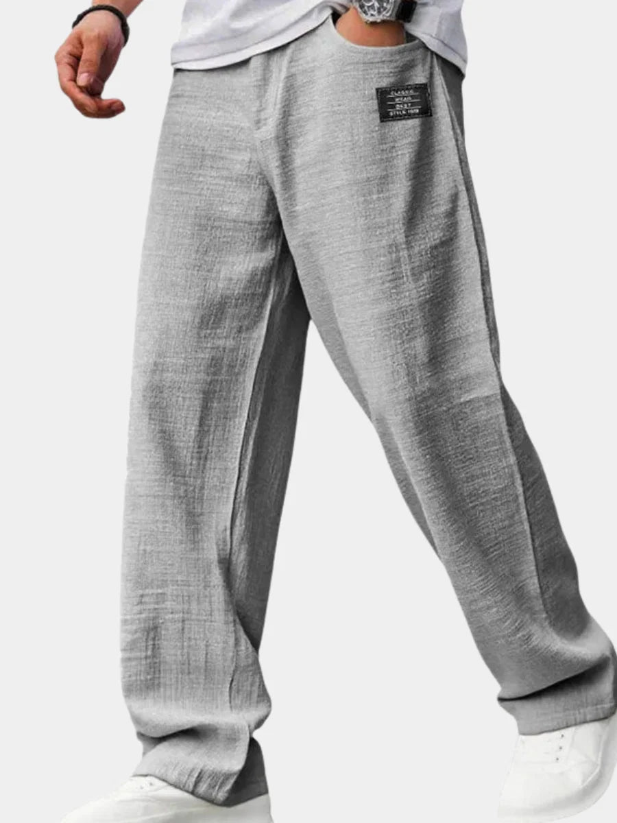 Men's straight leg trousers in grey with relaxed wide-leg fit and ribbed texture detail