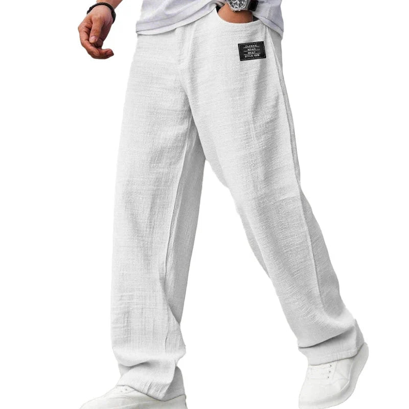 Side angle of men's relaxed fit straight leg trousers with wide silhouette and natural drape