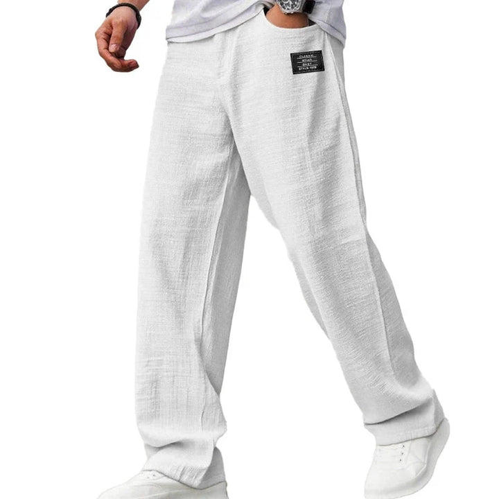 Side angle of men's relaxed fit straight leg trousers with wide silhouette and natural drape
