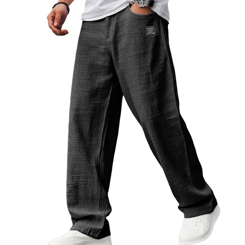 Detail shot of men's straight leg trousers featuring small patch pocket and structured fabric