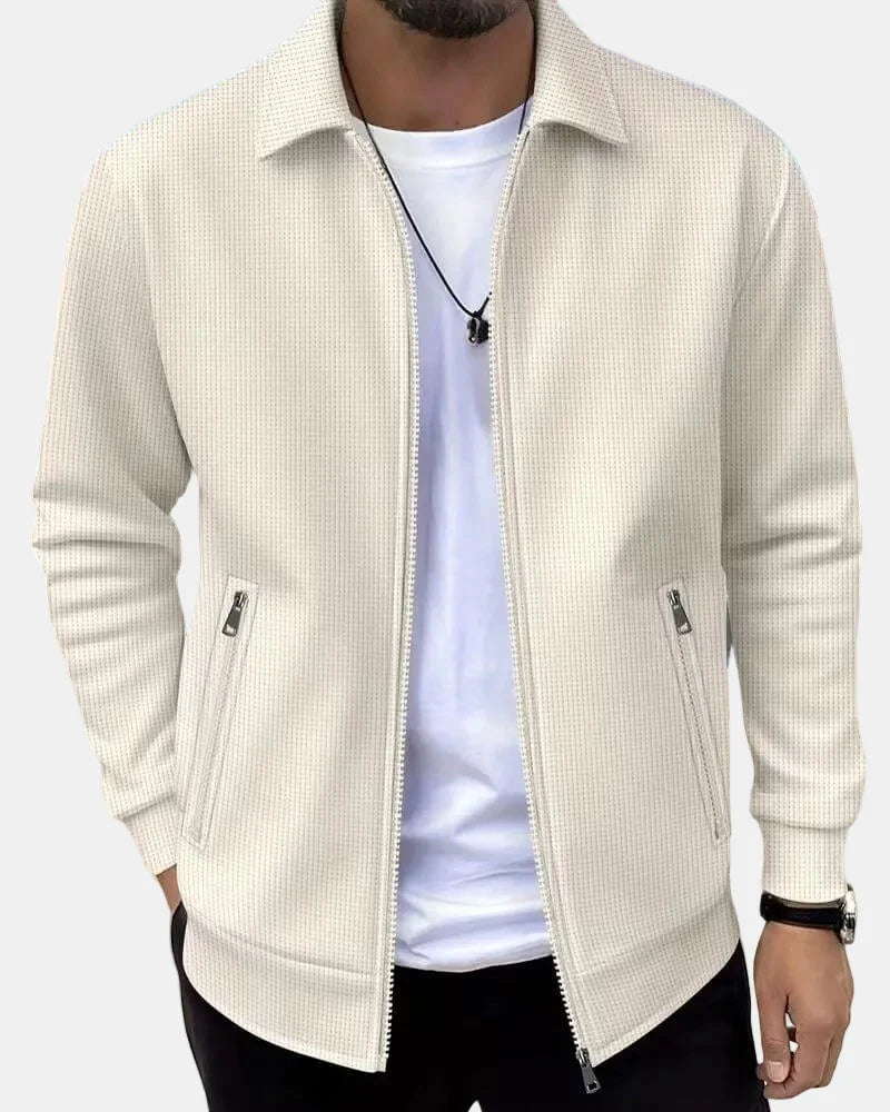 Men's textured zip-up jacket in cream with collared neckline and front zip pockets worn casually