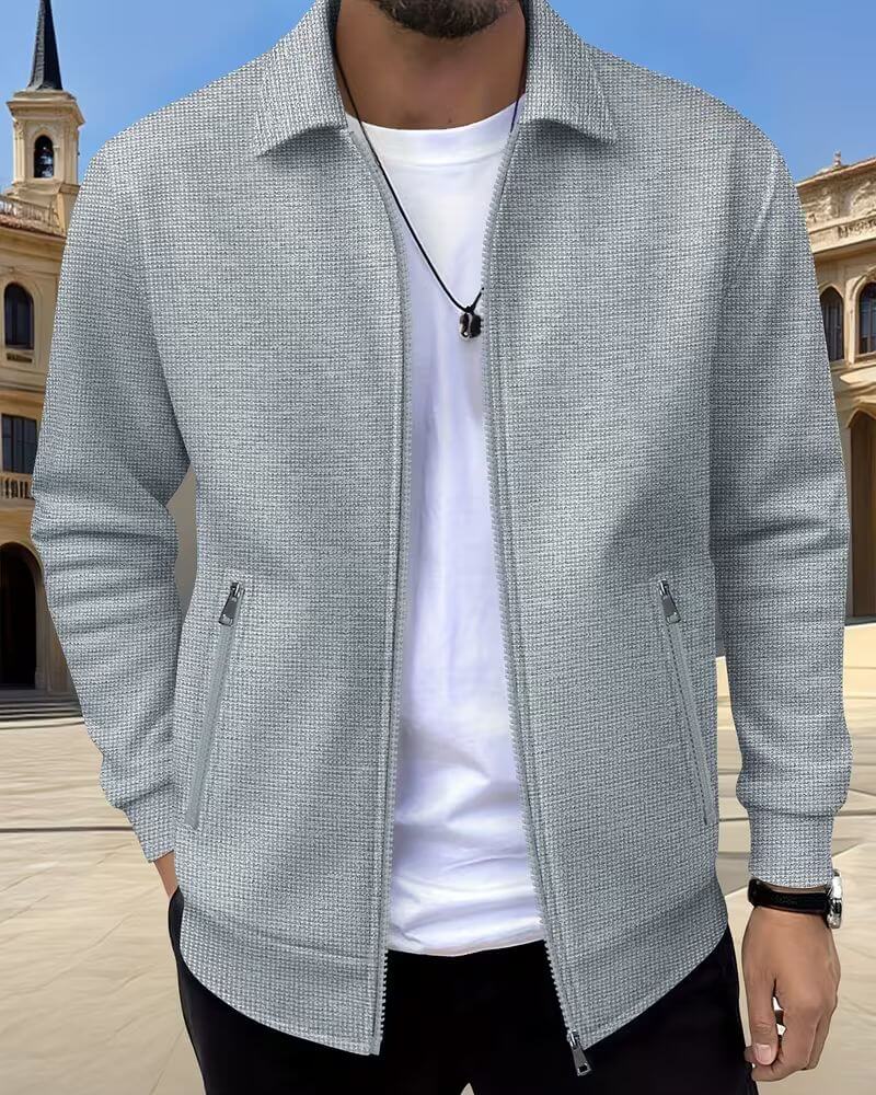 Close-up view of men's textured jacket showing subtle surface detail and zip closure construction