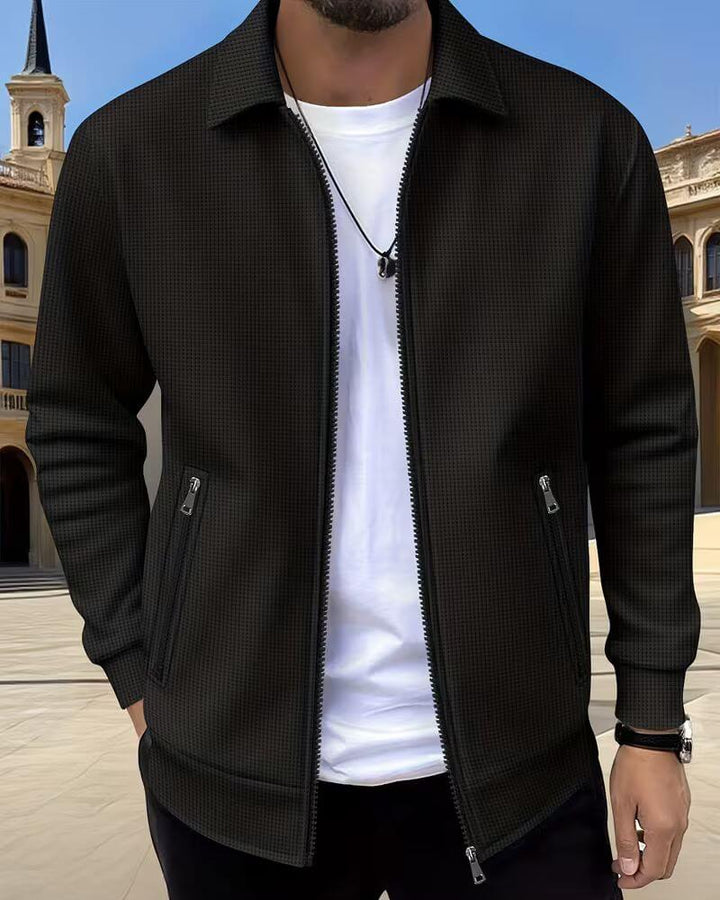 Side profile of men's textured zip-up jacket highlighting relaxed fit and ribbed cuffs detail