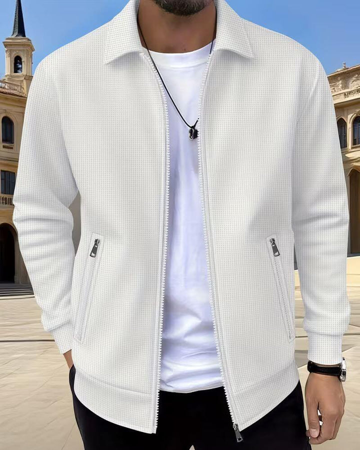 Men's cream textured jacket styled with white tee and black trousers for casual layering look