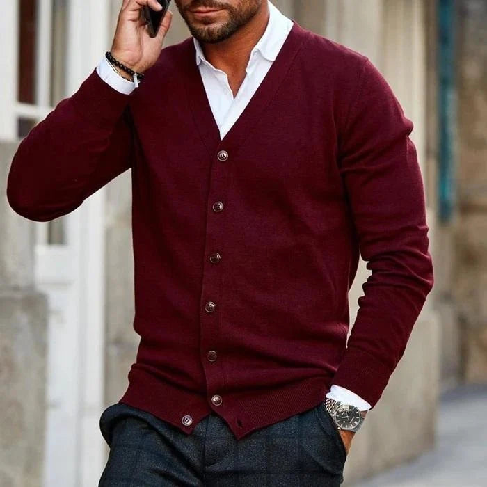 Man wearing burgundy men's v-neck cardigan with button-front closure over white collared shirt