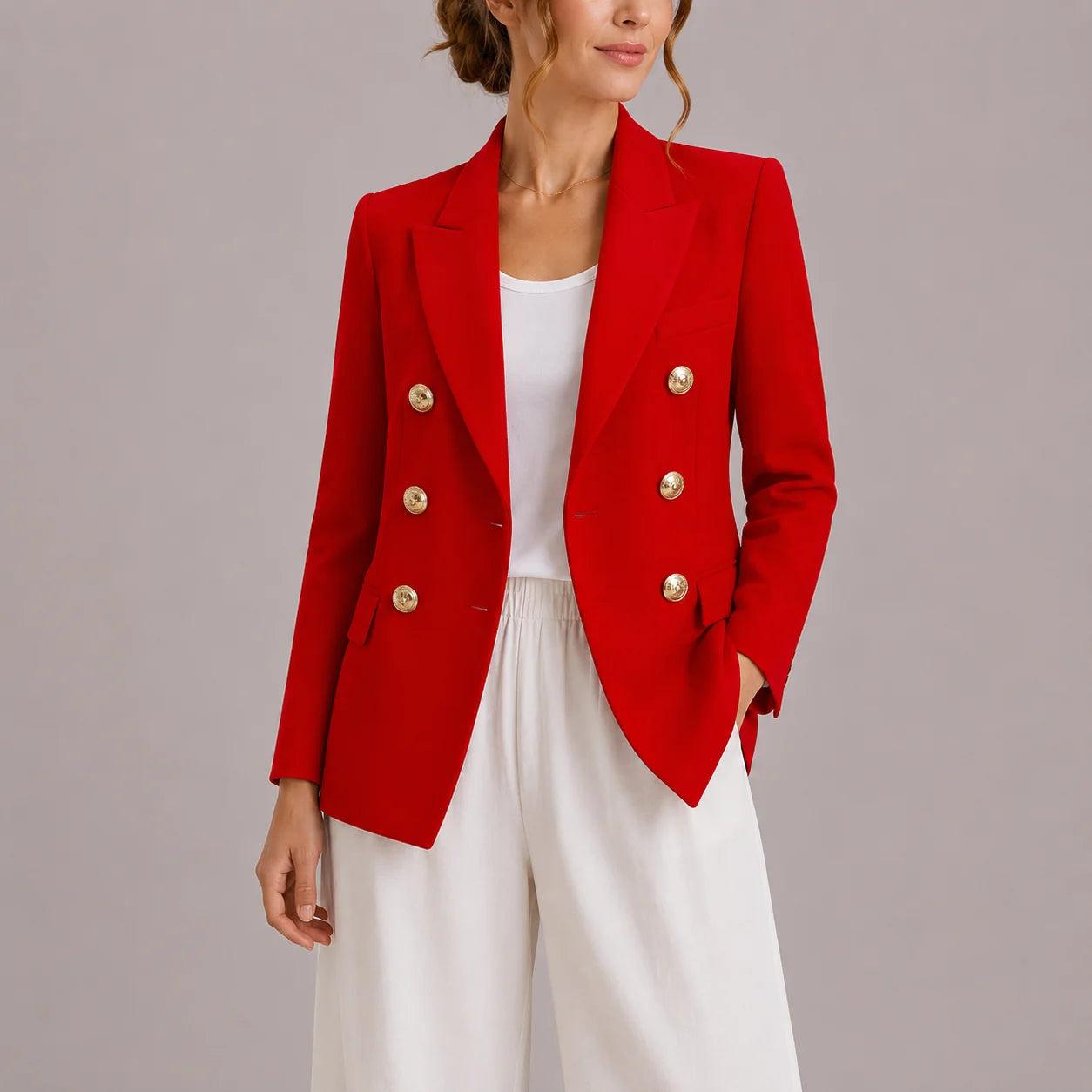 Women's double-breasted blazer styled with white outfit for polished office look