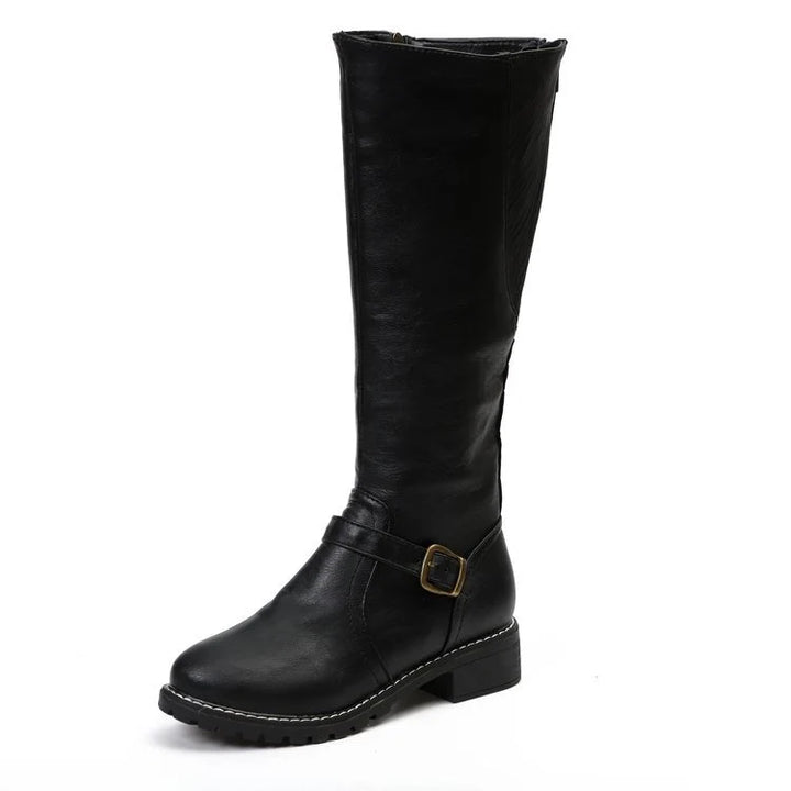 Close-up of women's knee-high boots showing smooth finish and ankle buckle strap