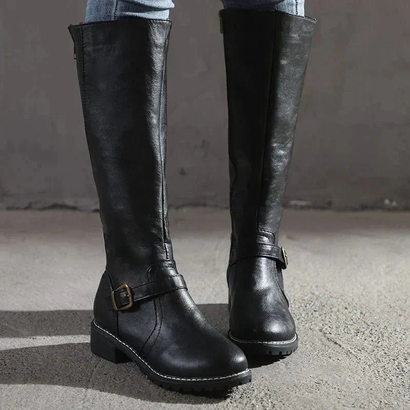Side view of women's knee-high boots with functional zip closure and block heel