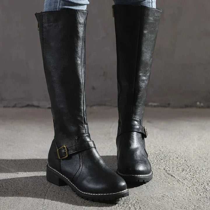 Side view of women's knee-high boots with functional zip closure and block heel