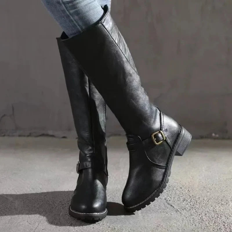 Women's knee-high boots in black featuring structured silhouette and treaded sole