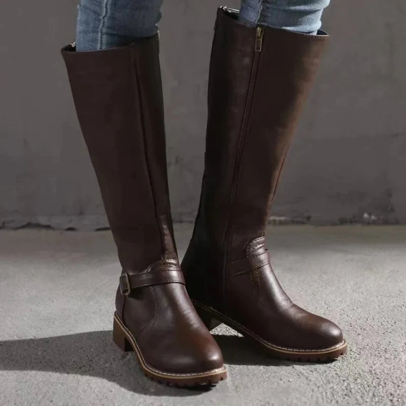 Women's knee-high boots in brown styled with casual trousers for everyday wear