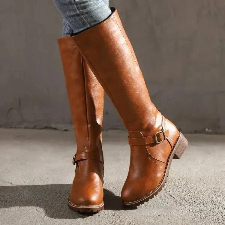 Close-up of women's knee-high boots sole with textured tread for stability