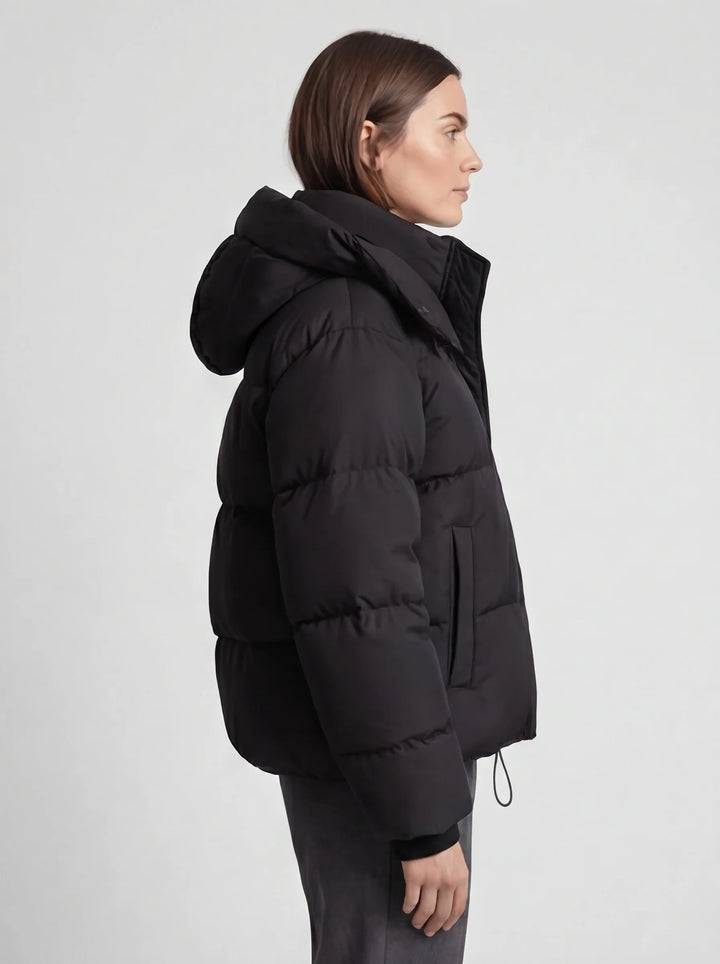 Women's cropped puffer jacket detail view highlighting ribbed cuffs and adjustable drawcord hem