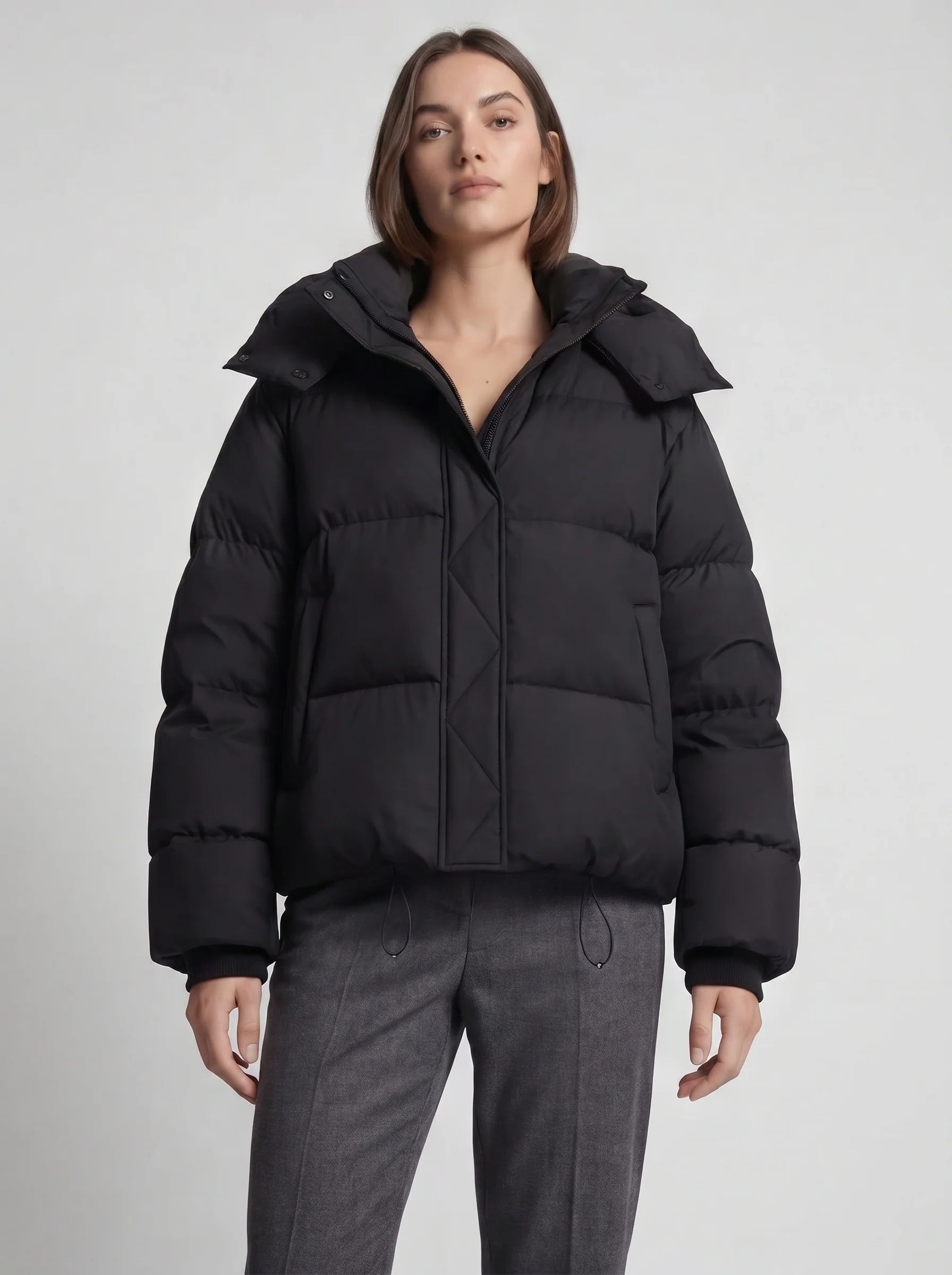 Oversized hooded puffer jacket side angle showing relaxed fit and structured quilted construction