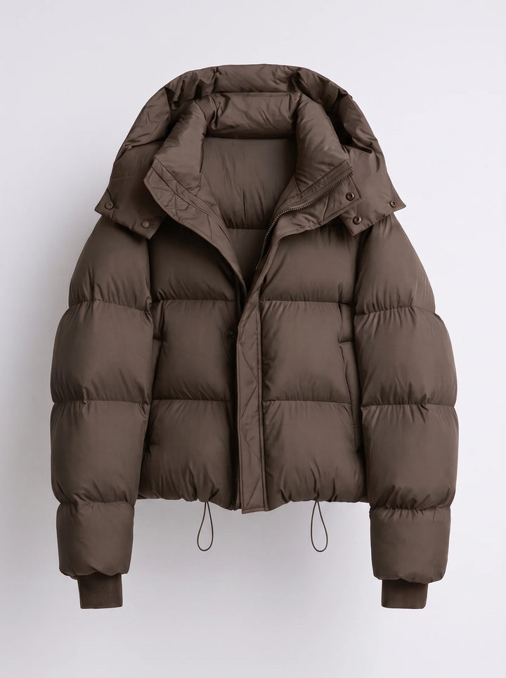 Women's puffer jacket close-up of zip-front closure with snap-button storm flap and hood