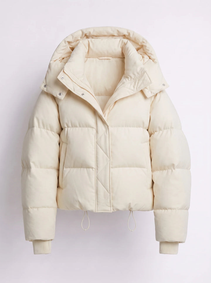 Hooded puffer jacket detail of adjustable hem drawcords and quilted fabric texture
