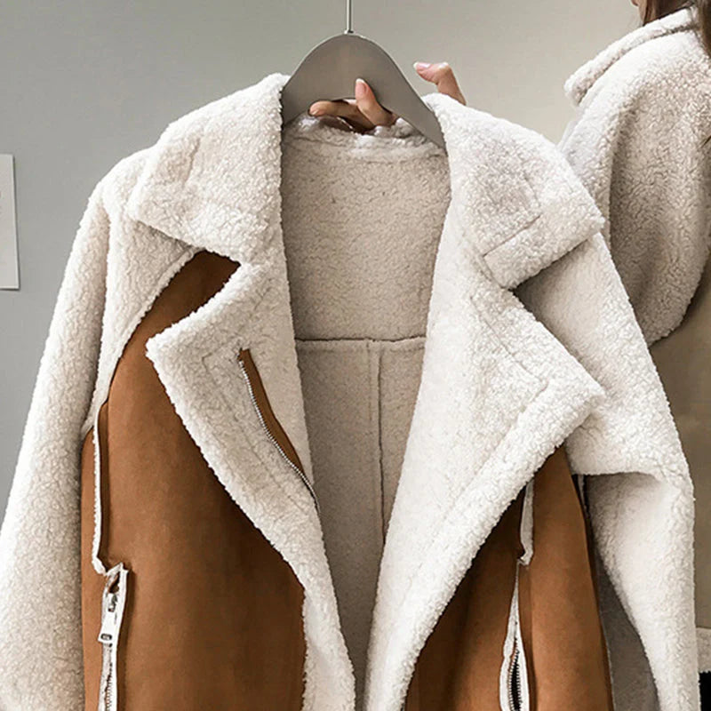 Close-up view of women's oversized sherpa jacket showing colour block design and ribbed cuffs