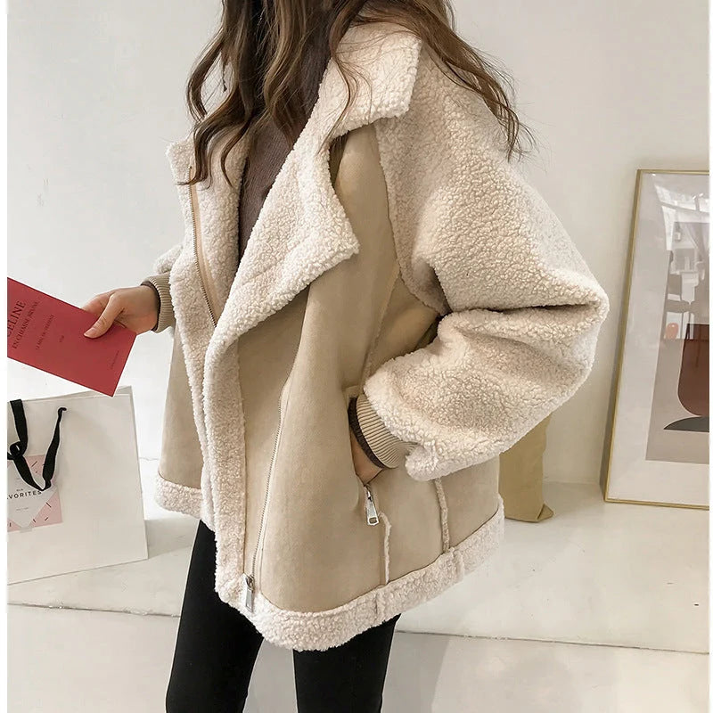 Detail shot of women's oversized sherpa jacket zip-up closure and plush fleece texture