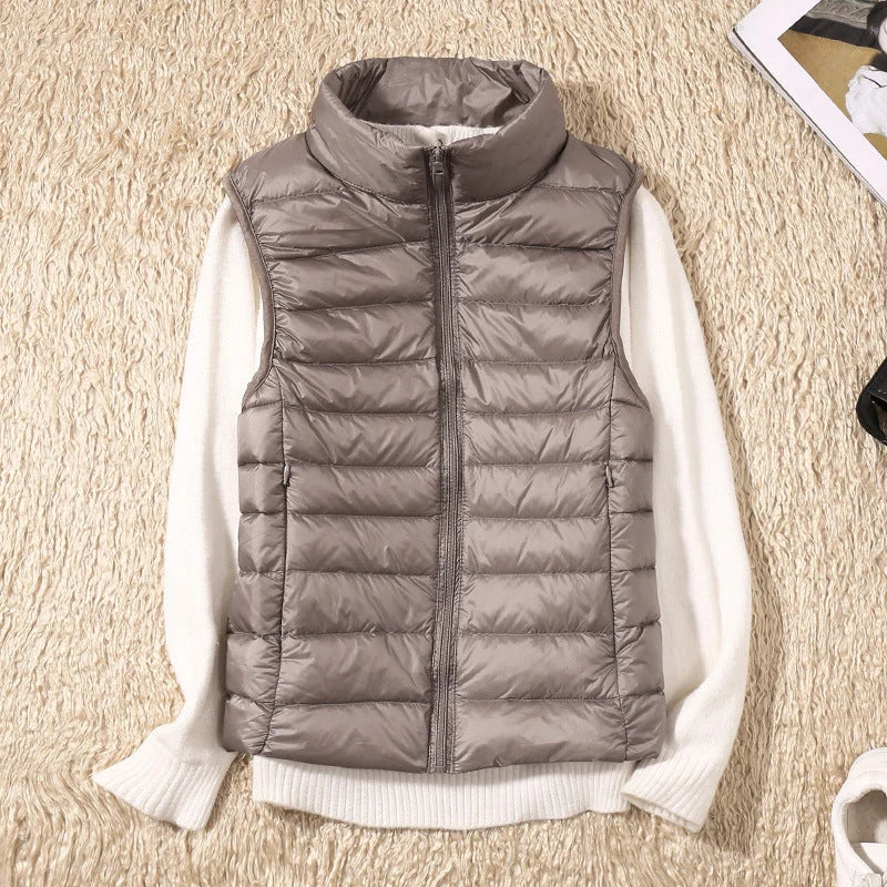Close-up of women's quilted gilet showing horizontal padded channels and structured fit at the hip
